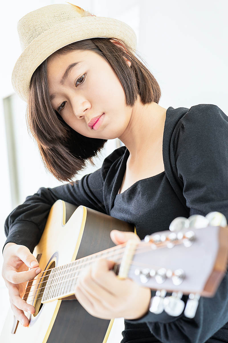 Close Up Woman Playing Guitar Crejd23.jpg